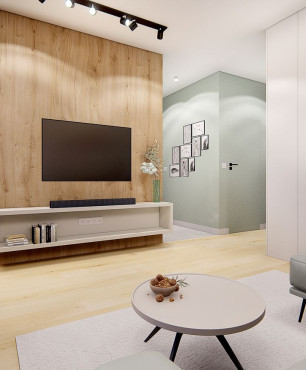 Telewizor zamontowany na ścianie działowej w salonie