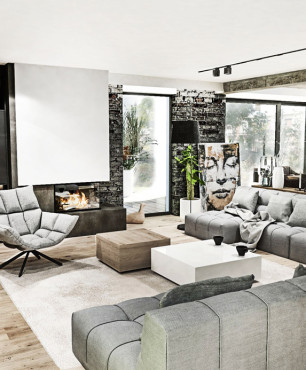 Salon z szarymi sofami i fotelem obracanym