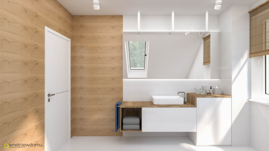 Łazienka z drewnianym akcentem na ścianie z białą szafką wiszącą