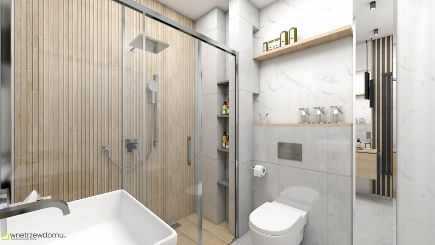 Łazienka z szarymi, dużymi płytkami na podłodze oraz imitacją drewnianych płytek pod prysznicem