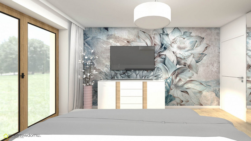 Sypialnia z telewizorem zamontowanym na ścianie z tapetą w kwiaty