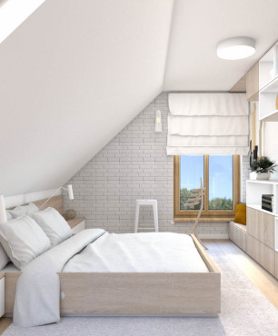 Sypialnia na poddaszu z białą cegłą na ścianie