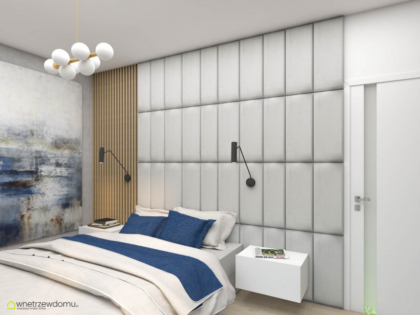 Sypialnia z tapicerowanymi, szarymi panelami na ścianie oraz z drewnem pionowym