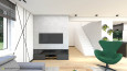Salon z telewizorem na ścianie oraz z zielonym fotelem