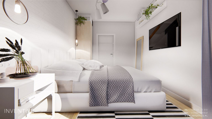 Sypialnia z łóżkiem kontynentalnym oraz z telewizorem na białej ścianie