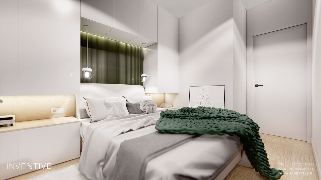 Sypialnia z zieloną tapetą nad łóżkiem kontynentalnym