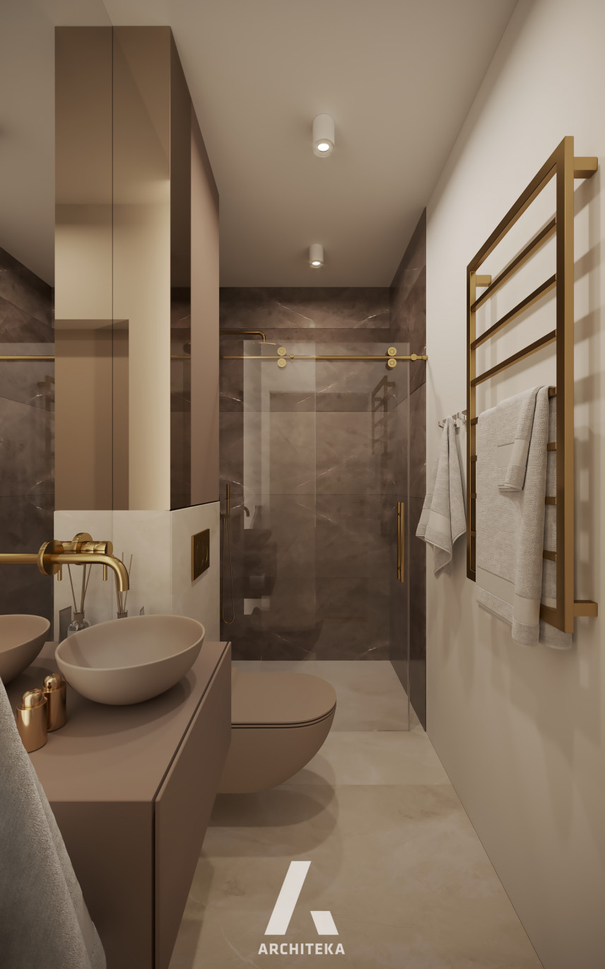 Wąska łazianka z ciemnymi, dużymi płytkami położonymi w kabinie prysznicowej
