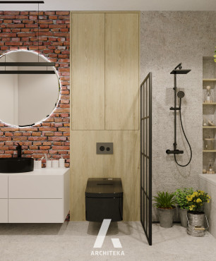 Łazienka z cegłą na ścianie oraz okrągłym lustrem