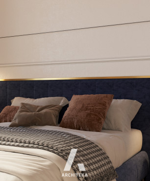 Granatowe, tapicerowane łóżko kontynentalne w sypialni
