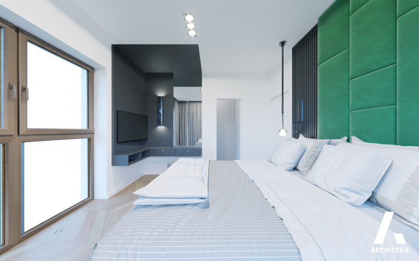 Sypialnia z zielonymi panelami tapicerowanymi na ścianie