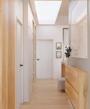 Wąski, biały korytarz z drewnianą komodą