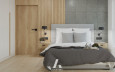 Sypialnia z betonem architektonicznym na ścianie oraz z lamelem ściennym