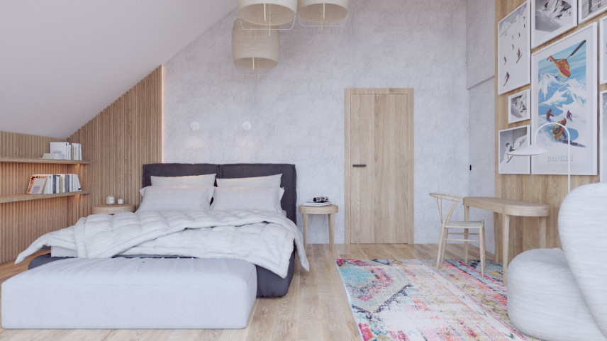 Sypialnia ze skosem, z drewnianą boazerią oraz betonem na ścianie