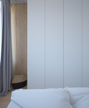 Sypialnia z białą szafą na wymiar pod sam sufit