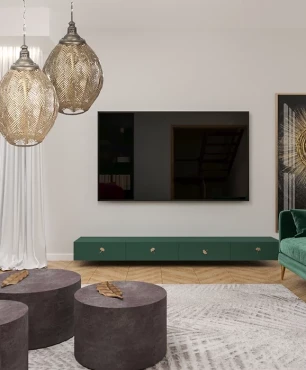 Nowoczesny salon z zieloną, welurową sofą oraz złotymi lampami wiszącymi