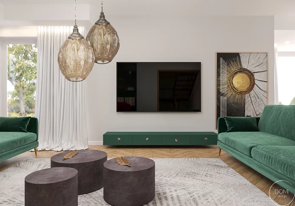 Nowoczesny salon z zieloną, welurową sofą oraz złotymi lampami wiszącymi