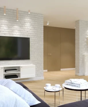 Salon z białą cegłą na ścianie oraz jasną wzorzystą tapetą