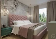 Kobieca sypialnia z tapicerowanym łóżkiem