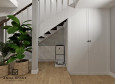 Projekt przedpokoju z białą szafą oraz schodami półkowymi