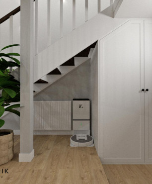 Projekt przedpokoju z białą szafą oraz schodami półkowymi