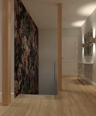 Wąski korytarz z tapetą w kwiaty na ścianie oraz ze schodami
