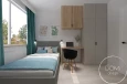 Pokój nastolatki z tapicerowanym łóżkiem, biurkiem oraz szafą