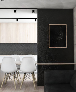 Salon z betonem architektonicznym na ścianie oraz czarnym narożnikiem