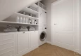 Pomieszczenie na poddaszu z pralką oraz suszarką