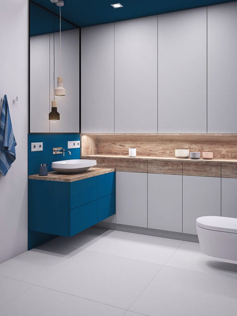 Projekt łazienki z intensywnym kolorem niebieskim na ścianie i szafce wiszącej