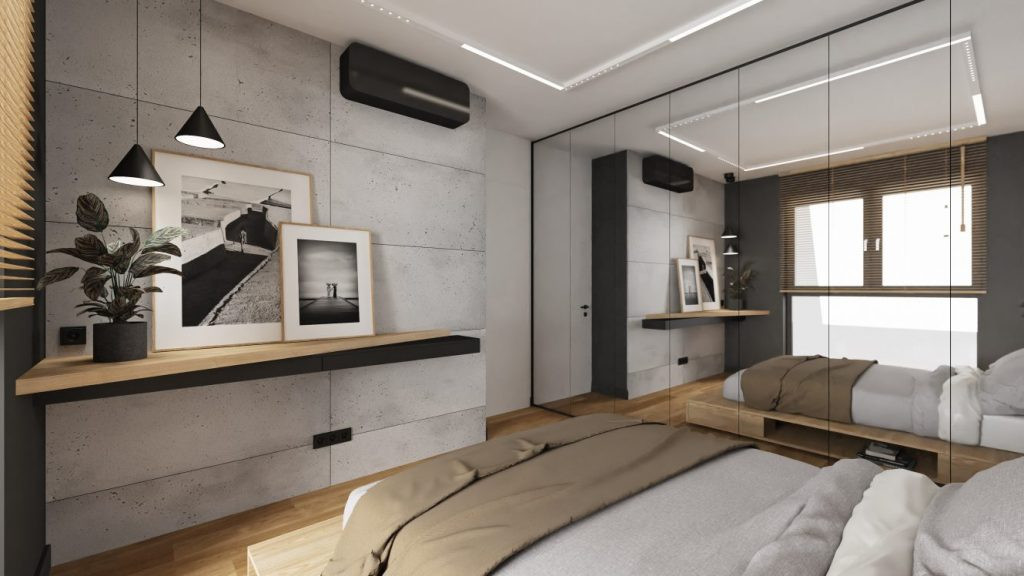 Sypialnia z imitacją betonu ozdobnego na ścianie oraz z szafą na całą ścianę