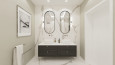 Mała łazienka z białym gresem na ściennie i podłodze oraz z dwoma eliptycznymi lustrami na ścianie