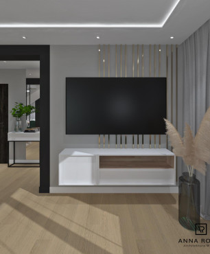 Salon z białą półką pod telewizor i drewnianymi lamelami