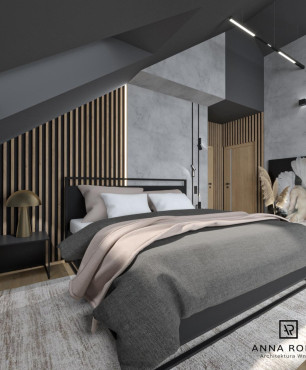 Sypialnia na poddaszu z lampami wiszącymi, łóżkiem i dywanem