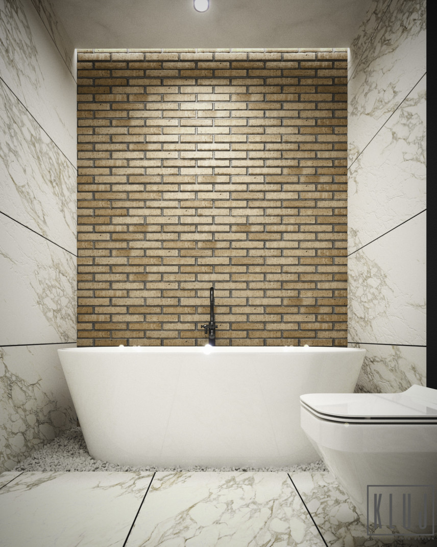 Łazienka z wanną ceramiczną wolnostojącą oraz z cegłą i marmurem na ścianie