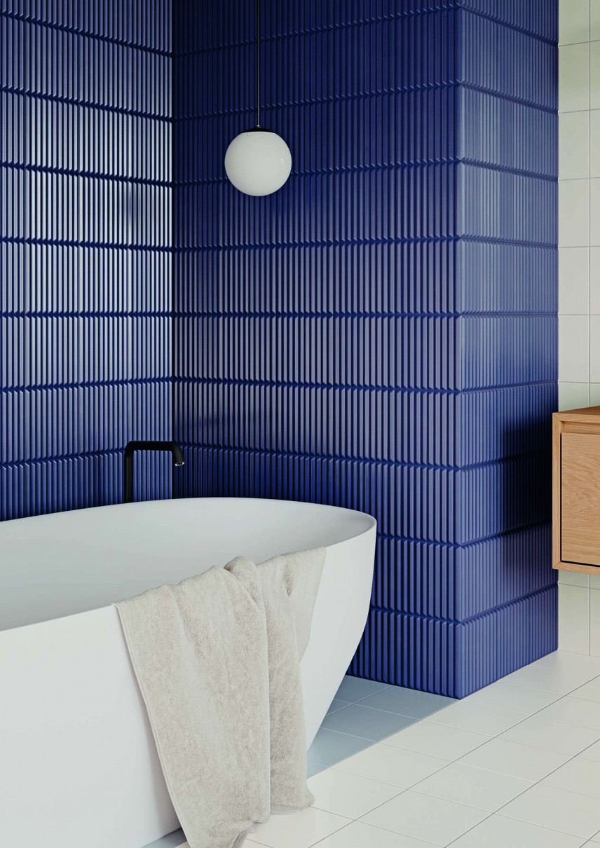 Aranżacja łazienki z wanną, owalną z płytkami na ścianie z głęboką strukturą w kolorze DARK BLUE oraz płytkami w kolorze BIANCO na podłodze