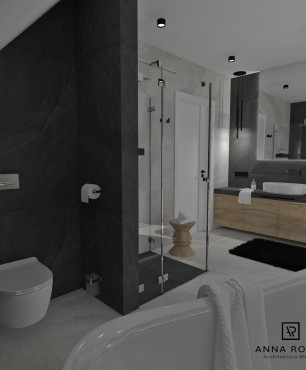 Łazienka w biało czarnym kolorze z elementami drewna