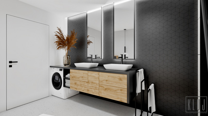 Projekt łazienki z pralką oraz jasną podłogą i czarnymi płytkami na ścianie