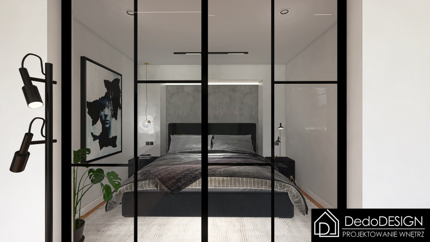 Sypialnia z dużym, tapicerowanym, czarnym łóżkiem kontynentalnym