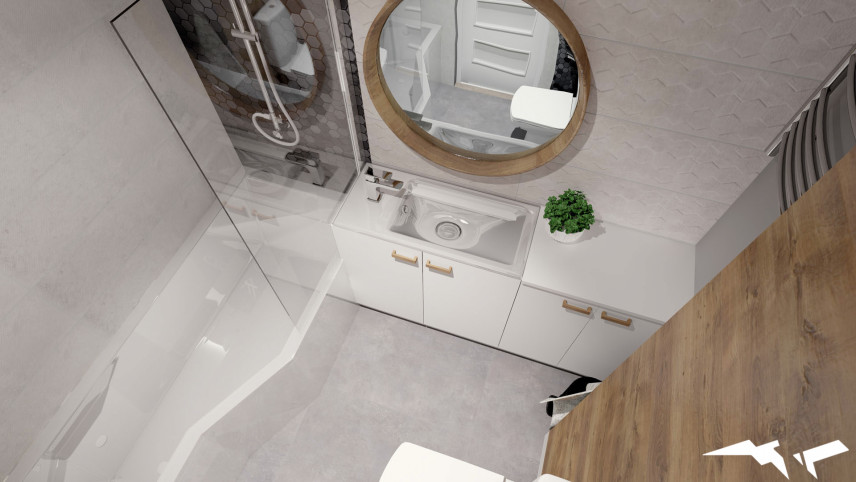 Łazienka z szarymi płytkami na ścianie i podłodze oraz z okrągłym lustrem w drewnianej ramie
