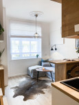 Salon połączony z kuchnią z drewnianym barkiem