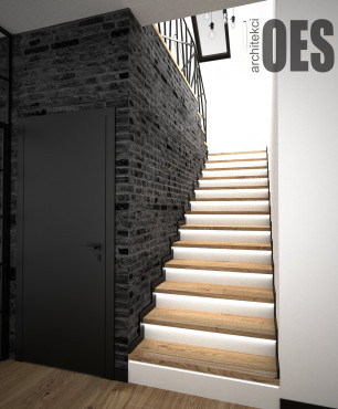 Drewniane schody jednobiegowe z czarną cegłą na ścianie