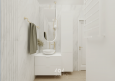 Biała łazienka wyłożona płytkami marmurowymi oraz z eliptycznym lustrem