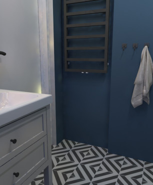 Łazienka z wzorzystą podłogą oraz granatowym kolorem ścian