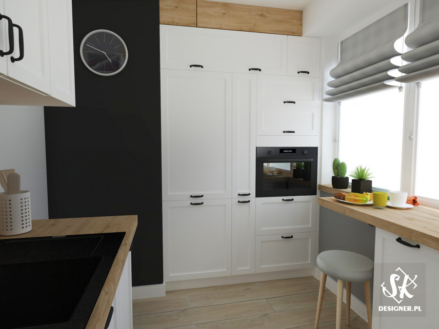 Kuchnia z białymi, frezowanymi szafkami oraz z czarnym kolorem ścian