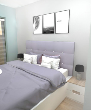 Mała sypialnia z białym tapicerowanym łóżkiem kontynentalnym