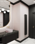 Projekt łazienki z eliptycznym lustrem w złotej ramie oraz z lekko różowymi płytkami na ścianie