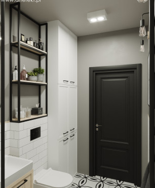 Łazienka z białymi meblami oraz biało-czarną podłogą