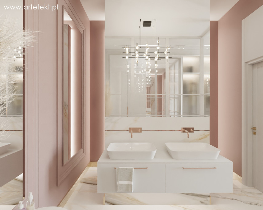 Łazienka z różowym kolorem ścian oraz białą szafką wiszącą