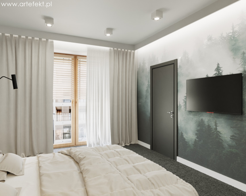 Sypialnia z leśną tapetą na ścianie