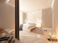 Duża sypialnia z białym, tapicerowanym łóżkiem kontynentalnym